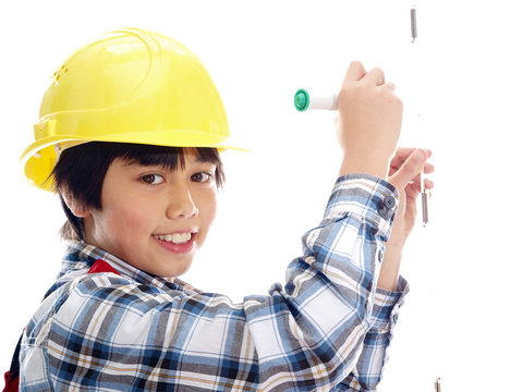 smiling boy wearing construction helmet