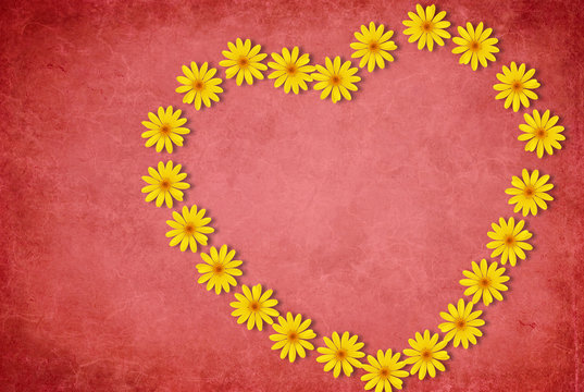 Heart made of flowers on red background