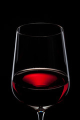 red wine in glass isolated on black