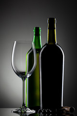 empty wine glass and bottles