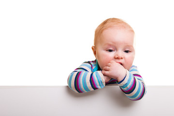Fototapeta na wymiar Isolated beaufiful caucasian infant baby behind whiteboard