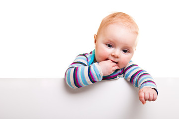 Isolated beaufiful caucasian infant baby behind whiteboard