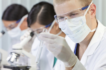 Male Scientist or Doctor With Test Tube In Laboratory