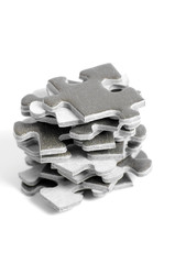 Stack of puzzle pieces on white background