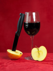 knife cutting a red apple