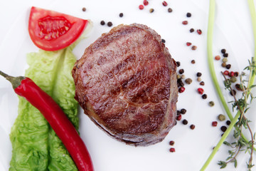 grilled beef fillet medallions with thyme on wood