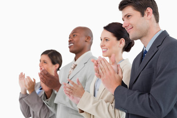 Side view of applauding salesteam standing together
