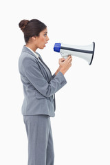 Fototapeta premium Side view of businesswoman using megaphone