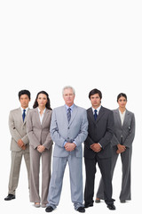 Mature salesman standing together with his team