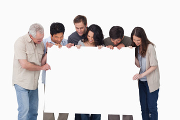 Group looking at blank sign in their hand