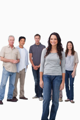 Obraz premium Smiling woman standing with friends behind her