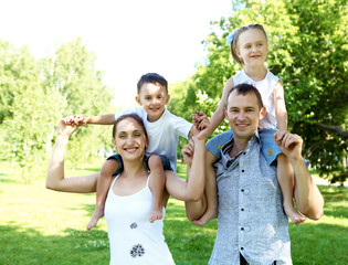 Family with two children in the summer park