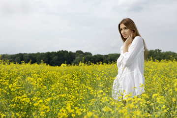 brunette woman in a yellow flowers field