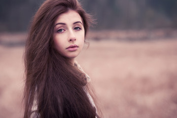 portrait of a beautiful brunette in a park