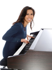 smiling teenage girl playing piano