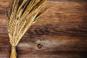 bunch of wheat ears on wood background