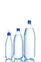 Group plastic bottles of water isolated on white