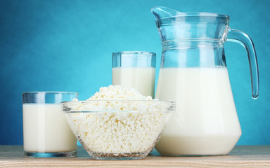 Dairy products on wooden table on blue background