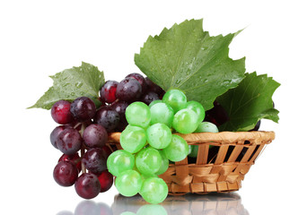 ripe green and red grapes in basket isolated on white
