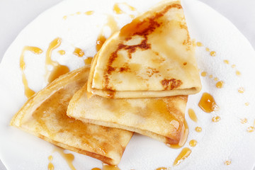 Thin pancakes with honey and powdered sugar
