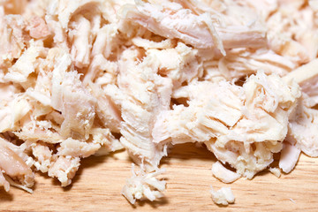 Cutting of chicken meat on a finishing kitchen board
