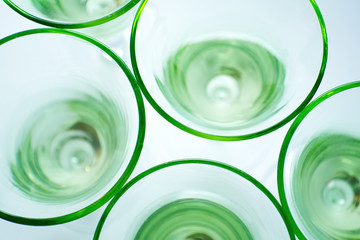Transparent green glasses on white background