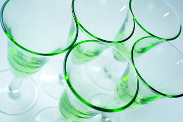 Transparent green glasses on white background