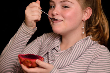 Girl with fruit pitahaya