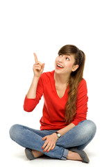 Obraz premium Young woman pointing up