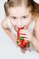 Strawberry time - girl eating strawberries