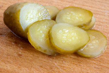 pickled cucumbers cut on the wooden board