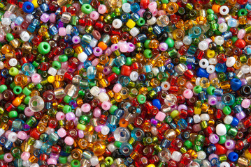 Fototapeta na wymiar Colorful polished glass beads background, macro