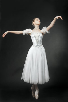 Beautiful dancer posing on studio background