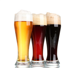 three glasses with different beers isolated on white