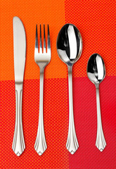 Fork, spoon and knife in a red cloth