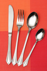 Fork, spoon and knife in a red cloth
