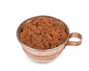 Brown sugar in a cup isolated white background