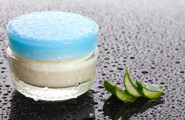 Closed glass jar of cream and aloe