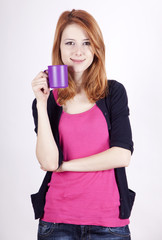 Portrait of red-haired girl with cup.