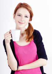 Portrait of red-haired girl with cup.