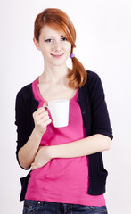 Portrait of red-haired girl with cup.