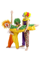 Three funny clowns in colorful wigs