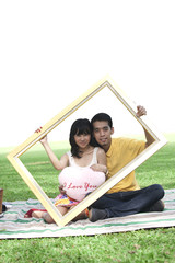 Young couple with rectangle frame