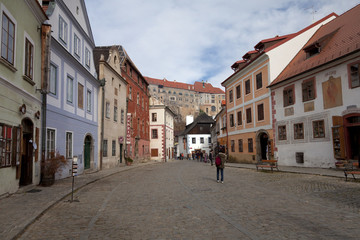 colorfull buildings line Krumlov streer, Castle above