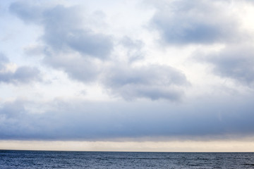 Fototapeta na wymiar Clouds over dark sea.