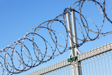 Fence with a barbed wire.