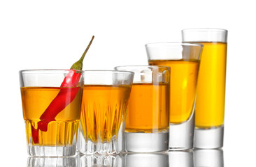 glasses of pepper vodka and red chili pepper isolated on white