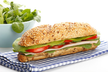 Footlong ham & swiss submarine sandwich on white background