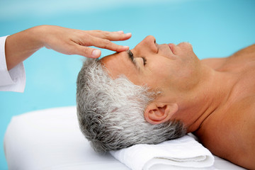 Mature man having facial massage - Powered by Adobe