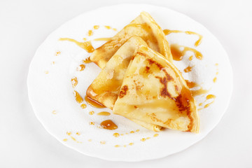 Thin pancakes with honey and powdered sugar